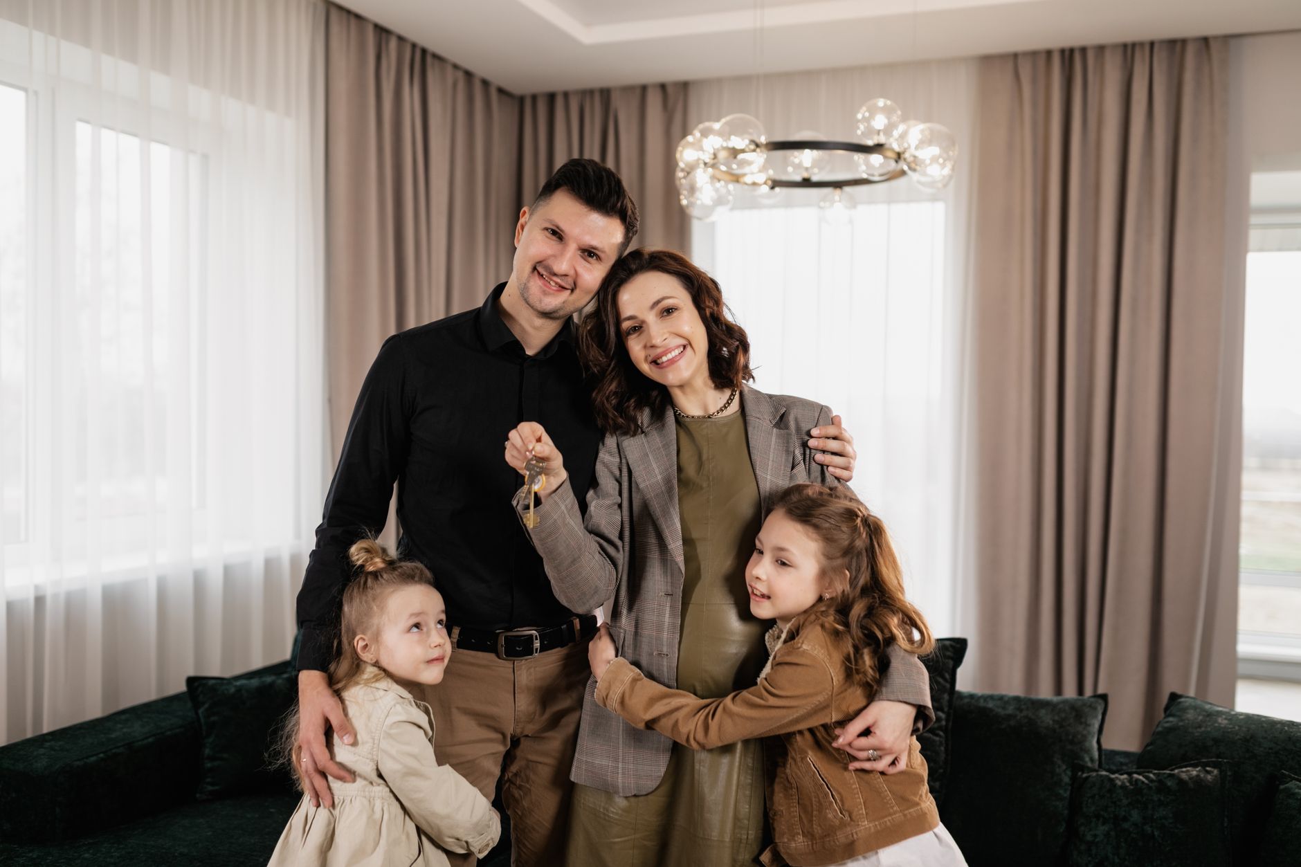 A family holding the keys to their new home
